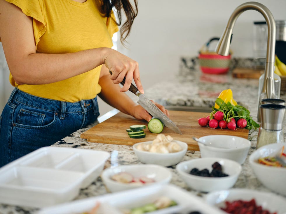 a woman preparing vegetarian meals in her home kitchen.
