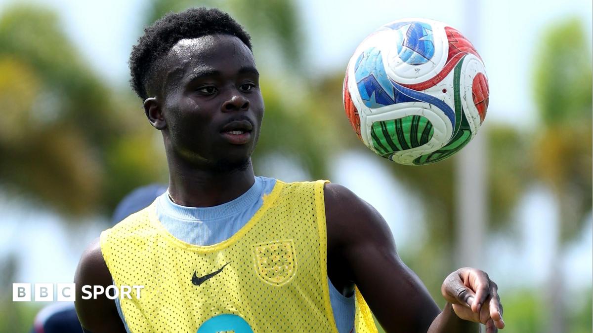 Bukayo Saka tosses a football in the air during an England training session in Florida