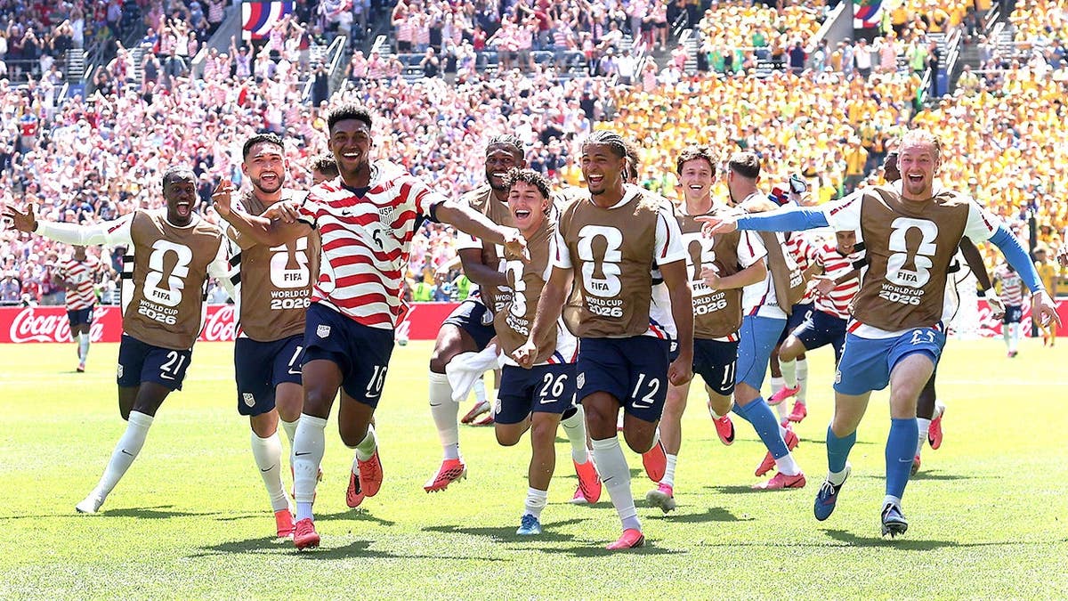 Alex Freeman celebrating with teammates after scoring a goal at Seattle Stadium.