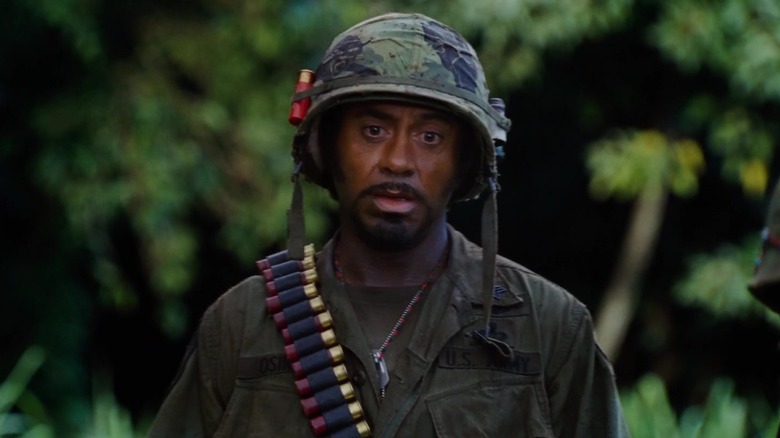 Robert Downey Jr. as Kirk Lazarus walking through the jungle in Tropic Thunder