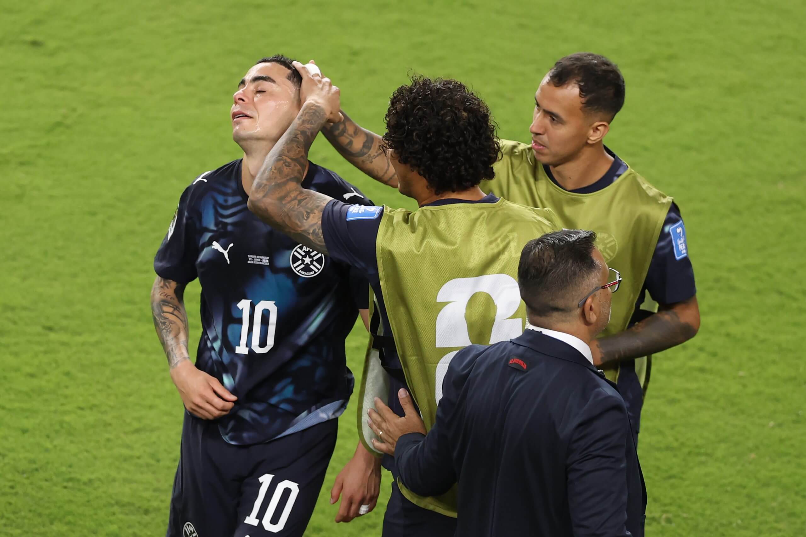Almiron consoled by teammates