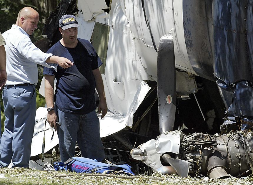 National Transportation Safety Board and Missouri State Patrol investigators pore over the wreckage of a skydiving plane that crashed in Sullivan, Missouri, on July 29, 2006.