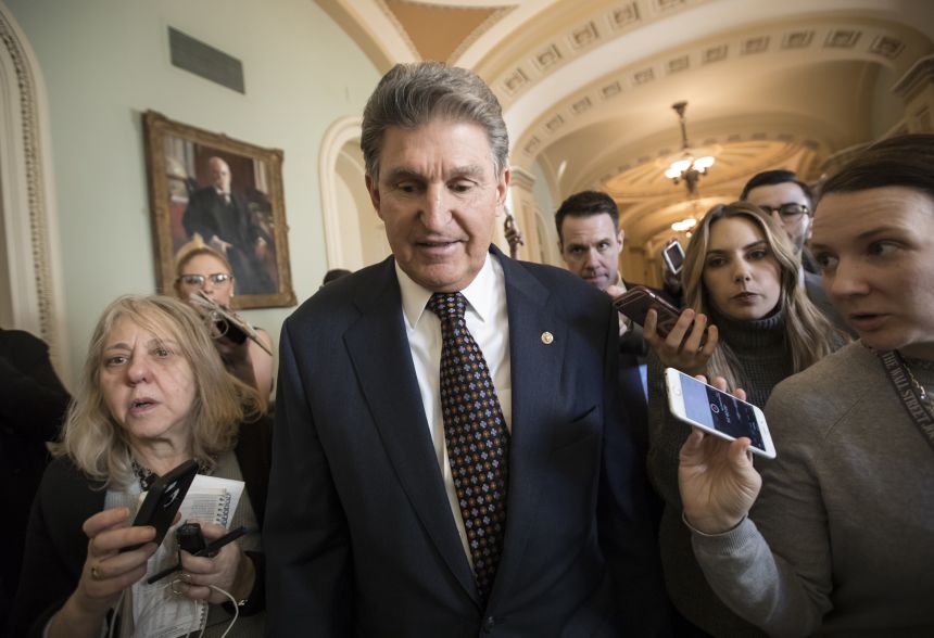 US Sen. Joe Manchin is seen surrounded by reporters at the Capitol in 2018.