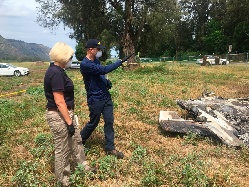 In this photo taken June 23, 2019, released by the National Transportation Safety Board, NTSB investigator Elliott Simpson, right, briefs NTSB board member Jennifer Homendy at the scene of a skydiving plane crash in Waialua, Hawaii.