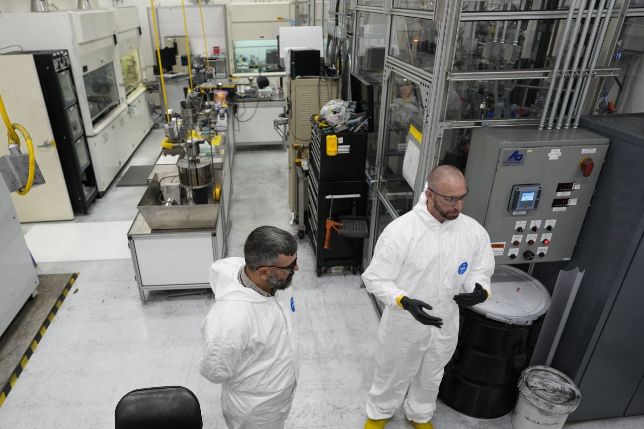 Tyler Gerczak, left, of Oak Ridge National Laboratory and Dan Brown, right, of TRISO-X a subsidiary of X-Energy, describe the method of manufacturing TRISO fuel in a laboratory on June 27, 2025, in Oak Ridge, Tennesee.