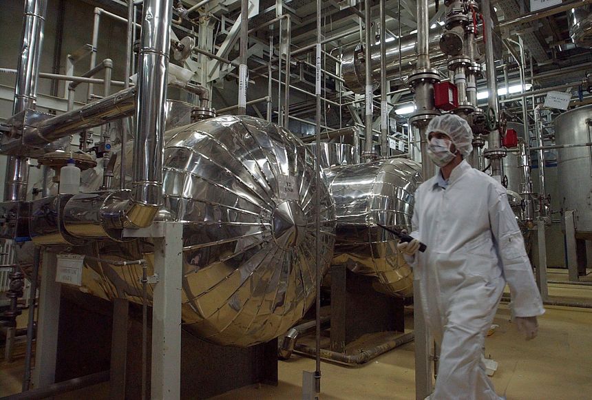 An Iranian security official in protective clothing walks through part of the Uranium Conversion Facility just outside the Iranian city of Isfahan, on March 30, 2005.