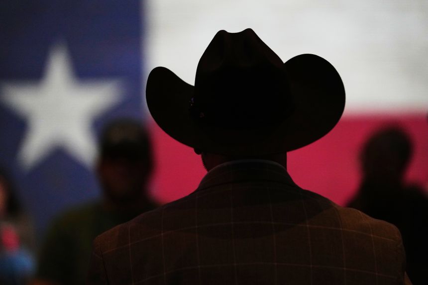 A cowboy hat and state flag are seen at a campaign event in February 2026 in Tyler, Texas.