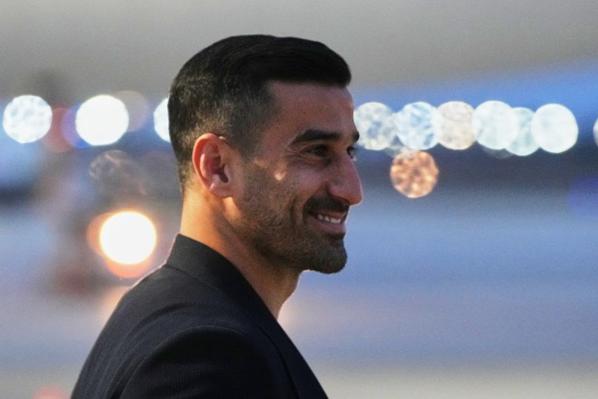 Iran's Ehsan Hajisafi smiles as he arrives with his teammates in Tijuana, Mexico, on Sunday ahead of this summer's World Cup in the United States.
