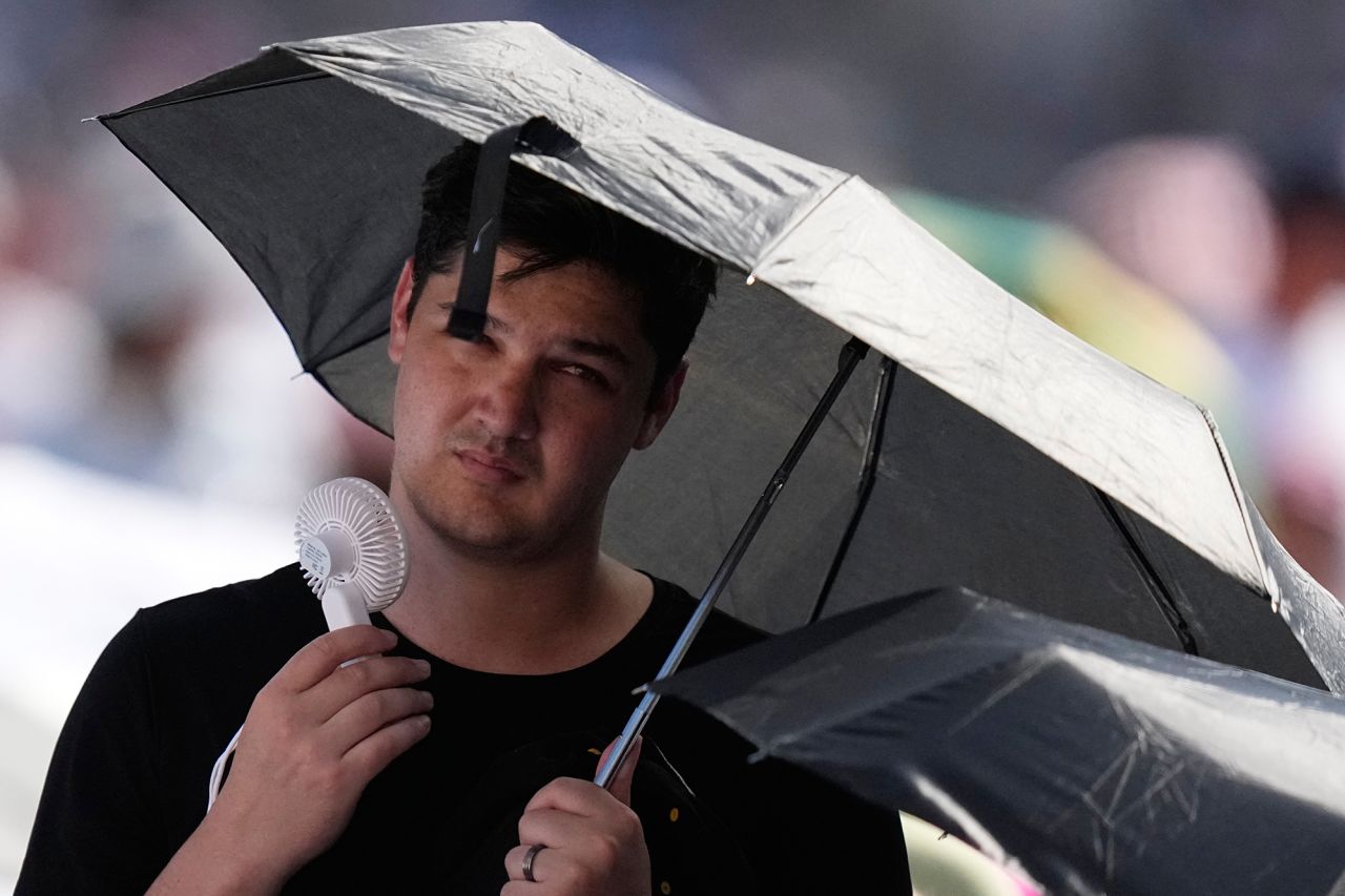 A faithful cools off as he waits for Pope Leo's XIV weekly general audience in St. Peter's Square at The Vatican on Wednesday.