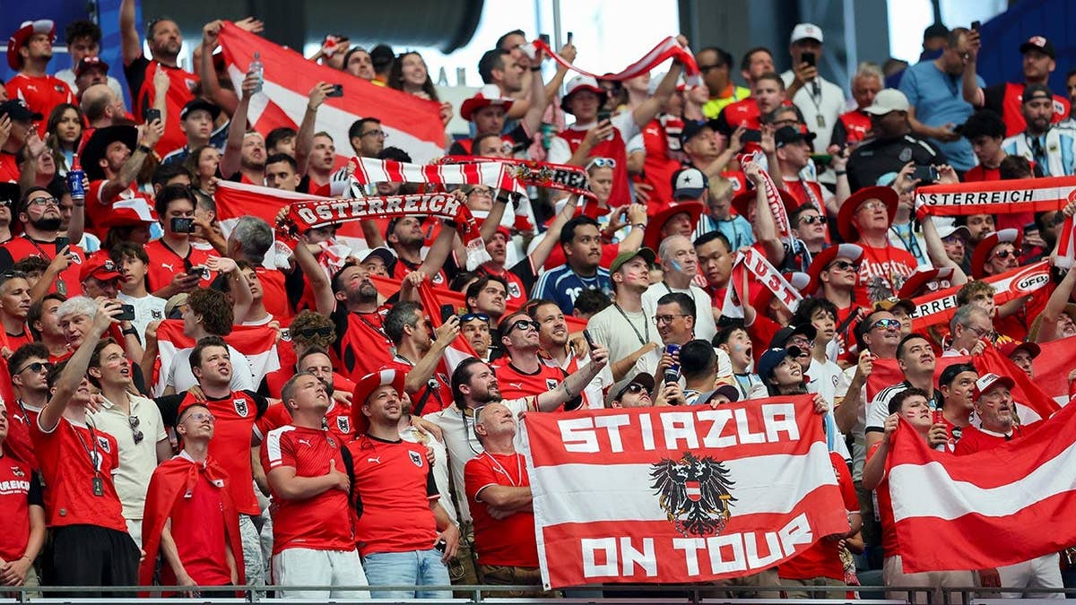 Supporters of Austria cheering at Dallas Stadium during FIFA World Cup 2026 match.