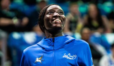 Forward Awak Kuier wearing a blue Dallas Wings warmup shirt while looking focused on the floor before a game.