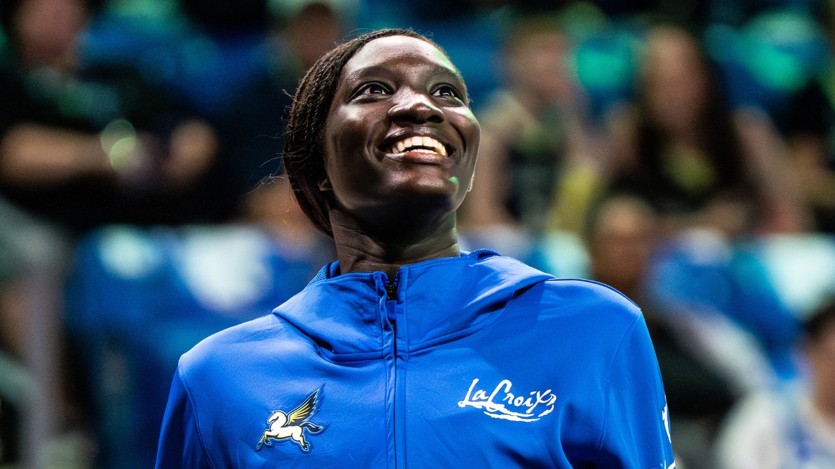 Forward Awak Kuier wearing a blue Dallas Wings warmup shirt while looking focused on the floor before a game.