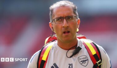 Dr Zafar Iqbal wearing an Arsenal training top and medical rucksack