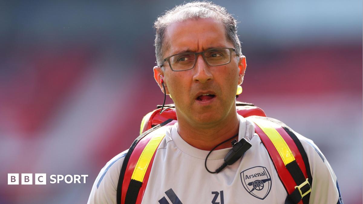 Dr Zafar Iqbal wearing an Arsenal training top and medical rucksack