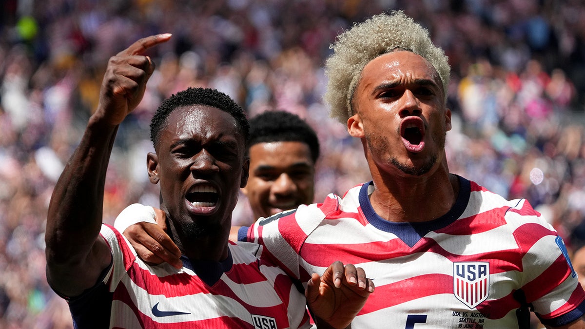 Folarin Balogun and Antonee Robinson celebrating during a soccer match in Seattle
