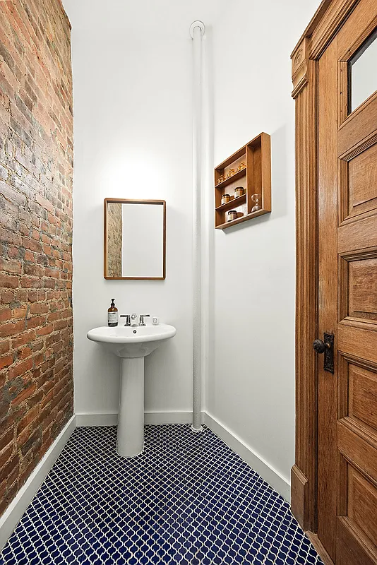 bathroom with blue tile floor, white pedestal sink