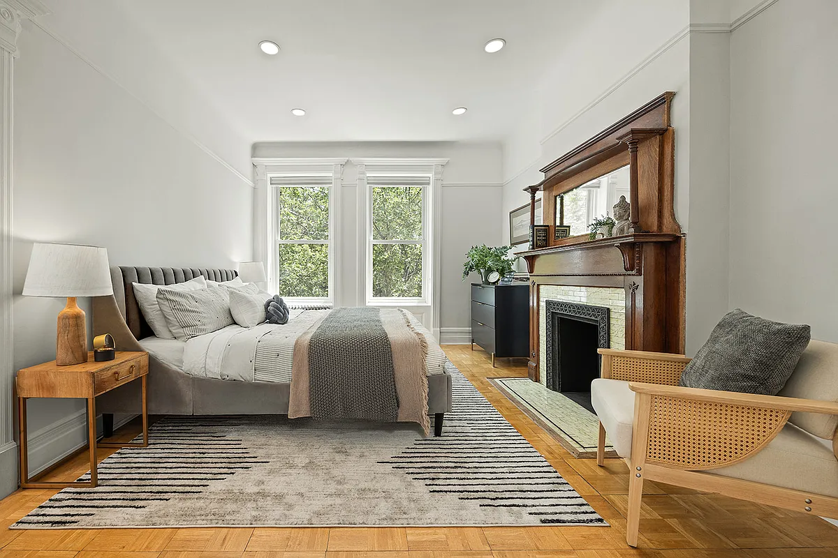 bedroom with white walls, mantel