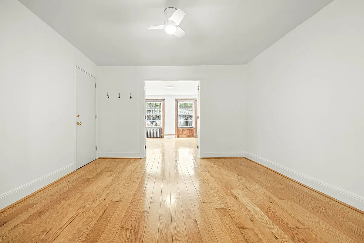 windowless living room on garden level with white walls