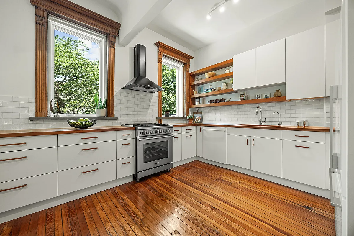 kitchen with white cabinets, white subway tile backsplash, two windows
