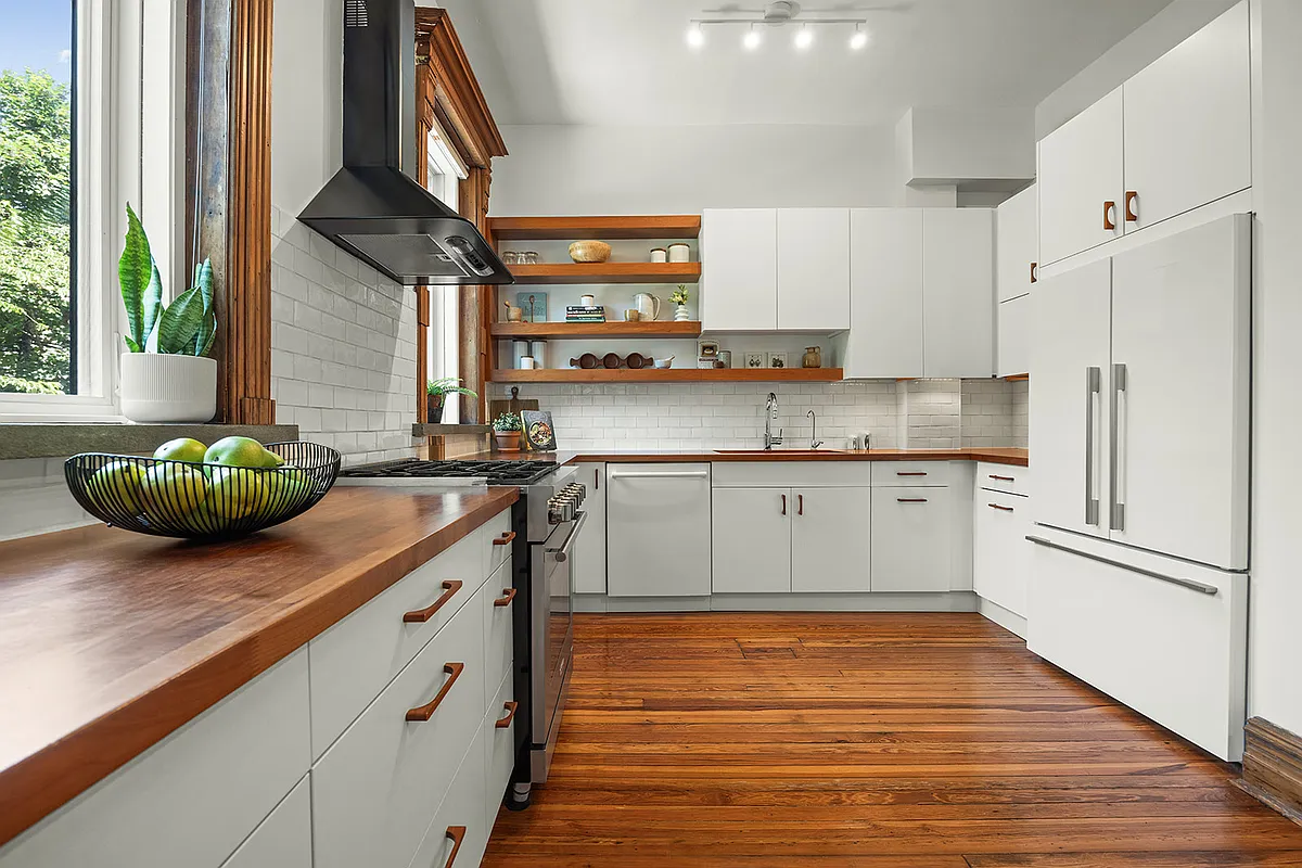 kitchen with white cabinets, white subway tile backsplash, two windows