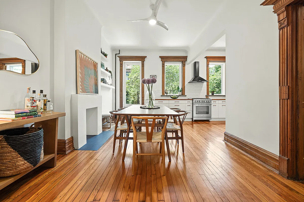 dining room with white walls and view into kitchen