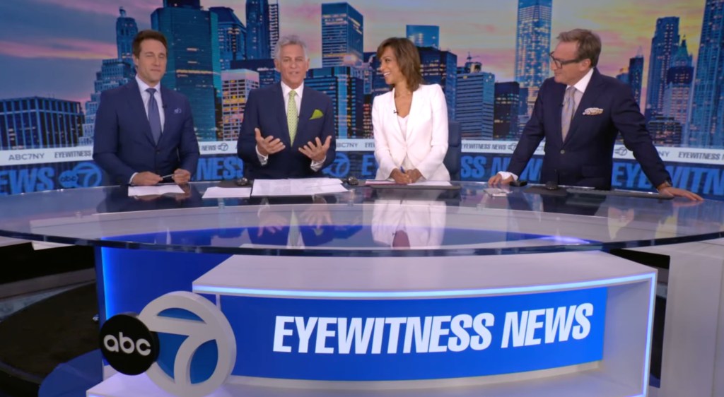Four news anchors, two men in suits and two women, seated at a desk with "EYEWITNESS NEWS" branding.