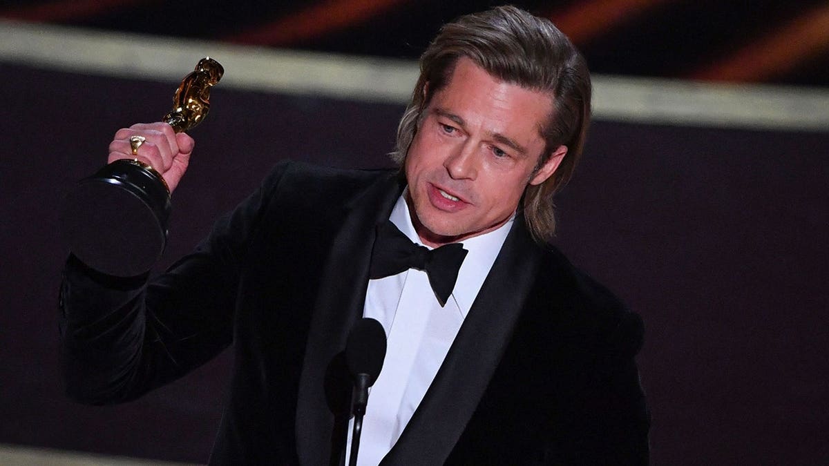 Brad Pitt accepting his Oscar on stage in Los Angeles in February 2020