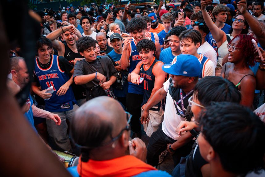 New York Knicks fans dance around and get ready for the game outside Madison Square Garden on June 5, in New York City.