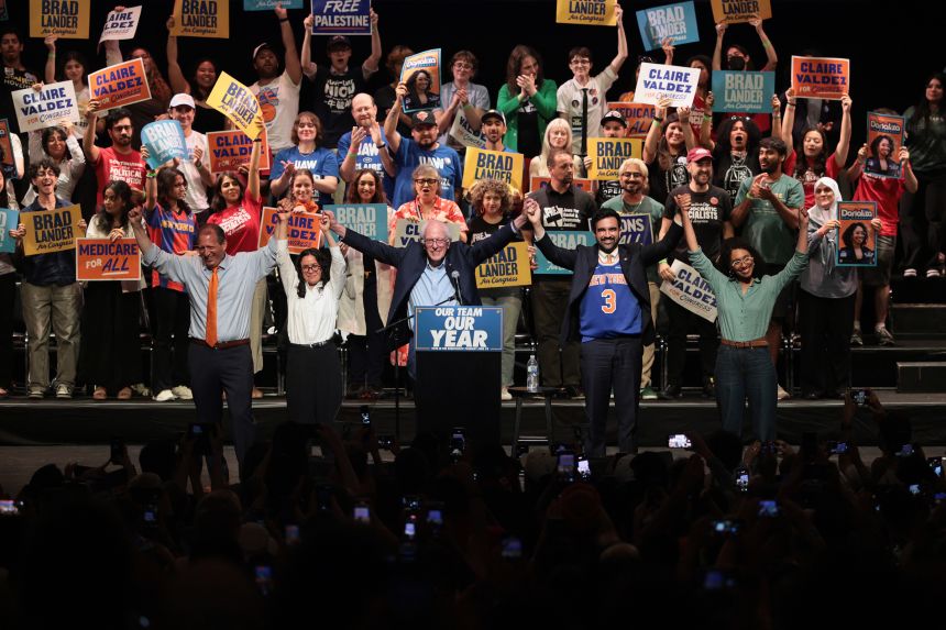 Congressional candidate Brad Lander, Congressional candidate Claire Valdez, Sen. Bernie Sanders (I-VT), Mayor Zohran Mamdani, and Congressional candidate Darializa Avila Chevalier raise their hands during a Get Out the Vote (GOTV) rally at Kings Theater on Thursday in New York City.