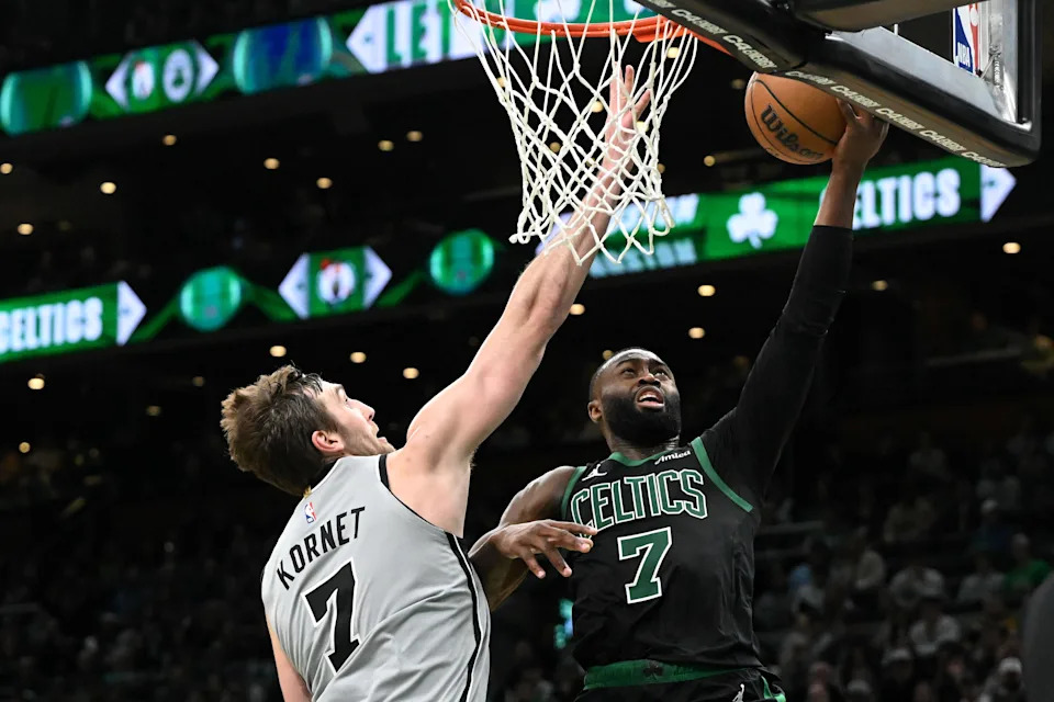 Jan 10, 2026; Boston, Massachusetts, USA; San Antonio Spurs center Luke Kornet (7) defends Boston Celtics guard Jaylen Brown (7) during the second half at the TD Garden. Mandatory Credit: Brian Fluharty-Imagn Images