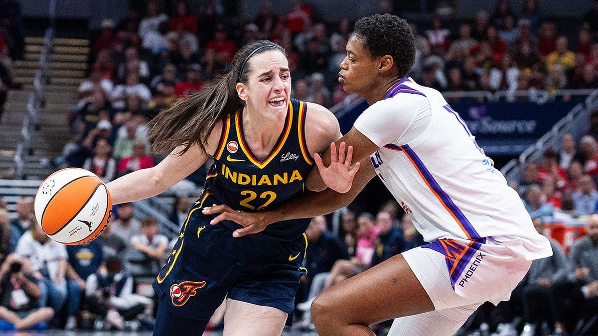 Indiana Fever guard Caitlin Clark dribbling basketball defended by Phoenix Mercury forward Valeriane Ayayi at Gainbridge Fieldhouse