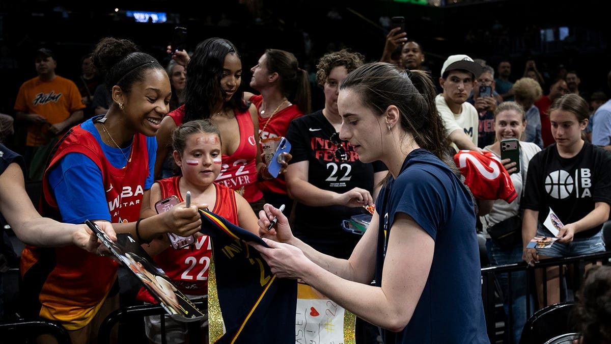 Caitlin Clark signing autographs for fans at Barclays Center in New York City