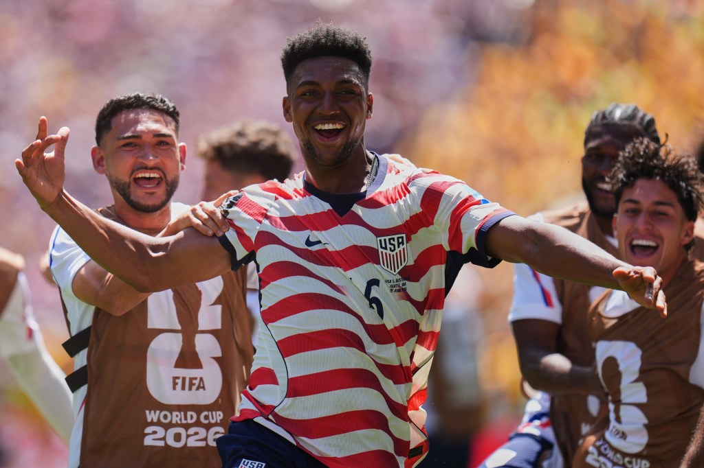 Alex Freeman (16) celebrates his second goal for the US against Australia.