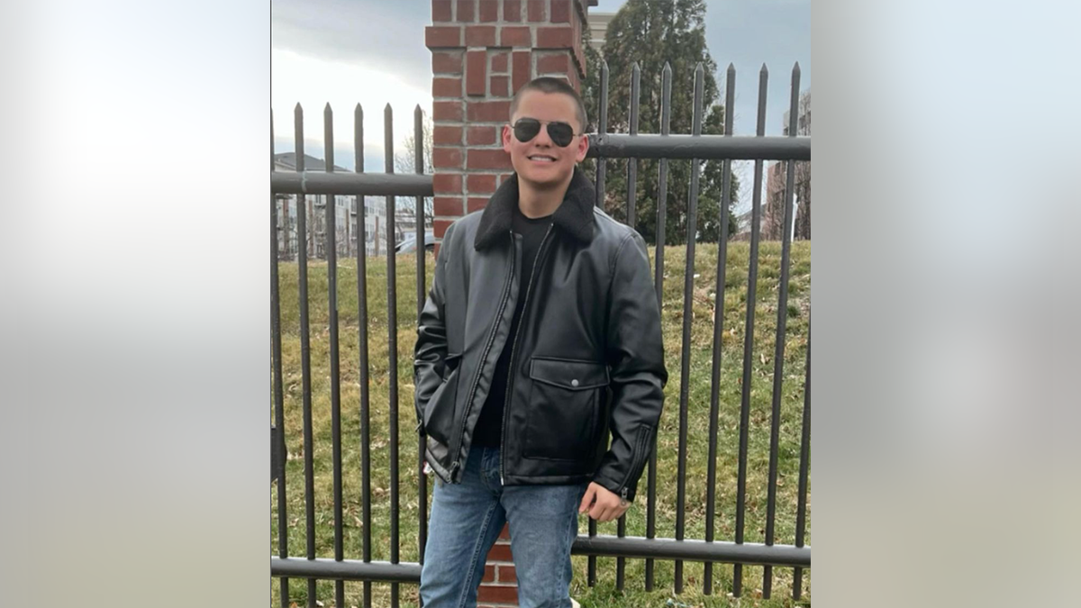 Collin Gosselin smiling wearing black jacket, jeans, and black sunglasses.
