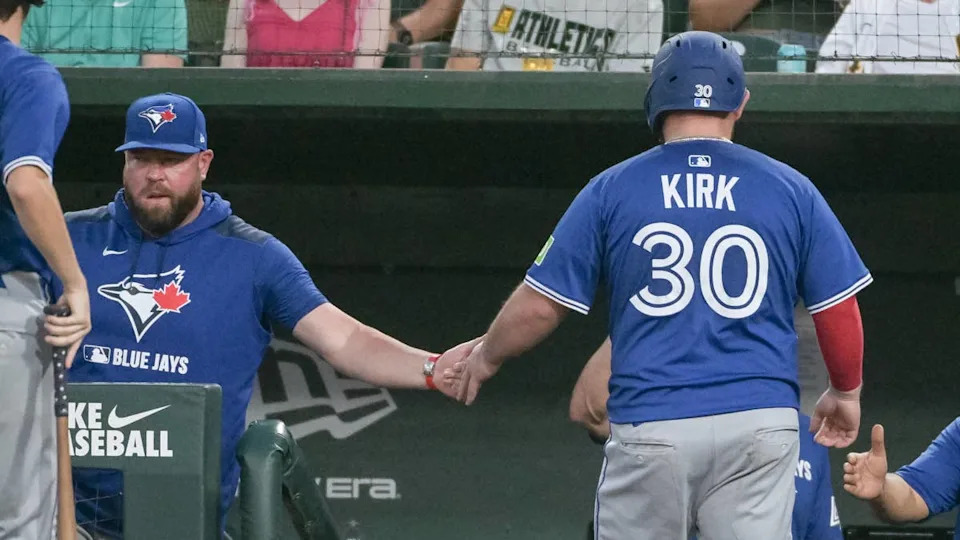 Toronto Blue Jays catcher Alejandro Kirk (30) and manager John Schneider.© Ed Szczepanski-Imagn Images