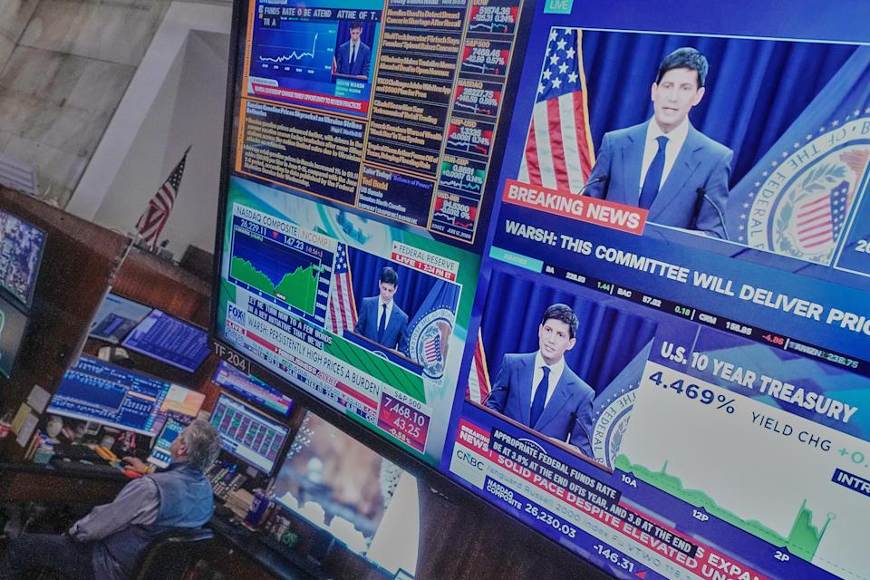 Federal Reserve Chair Kevin Warsh's press conference appears on screens on the floor of the New York Stock Exchange, Wednesday, June 17, 2026. (AP Photo/Richard Drew)