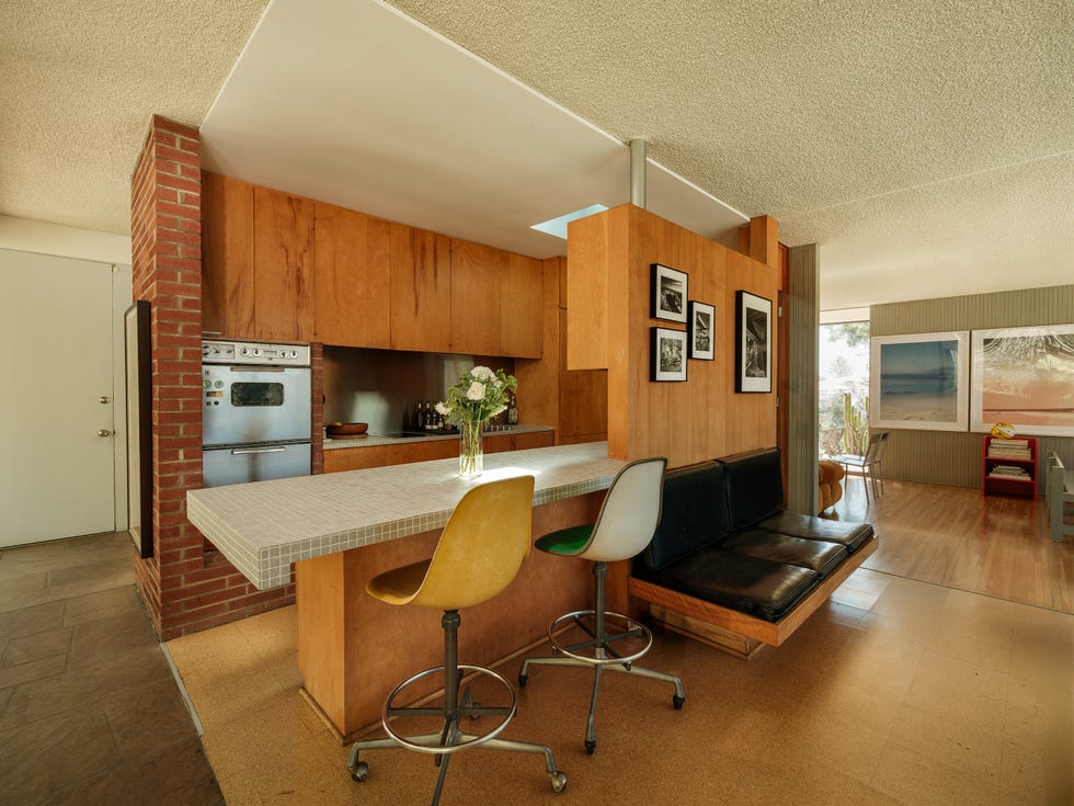 Modern kitchen and living area with seating and art