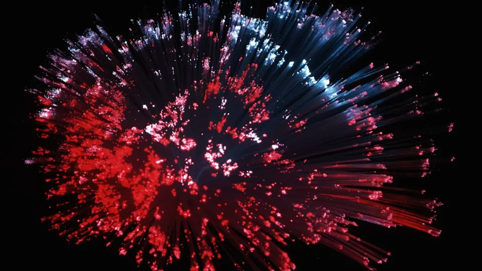 Colorful optical fiber cables against black background.