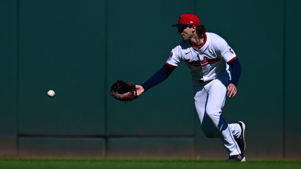 Cleveland Guardians center fielder Chase DeLauter misses a ball hit by Detroit Tigers' Gleyber Torres for a fielding error in the first inning of Game 2 of the American League Wild Card baseball playoff series in Cleveland, Wednesday, Oct. 1, 2025. (AP Photo/David Dermer)