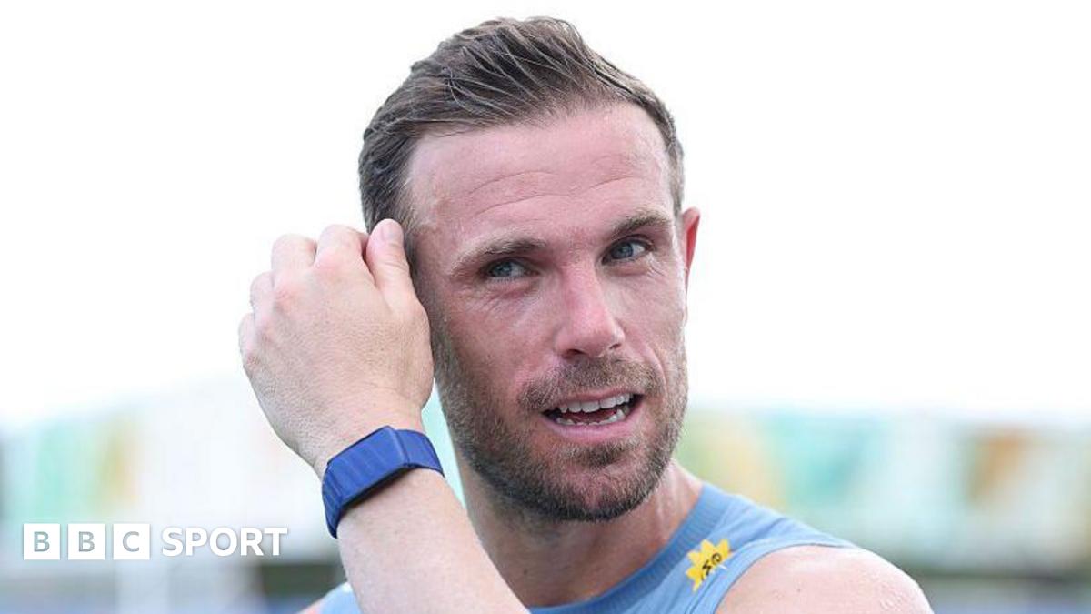 Jordan Henderson mops his brow during an England training session