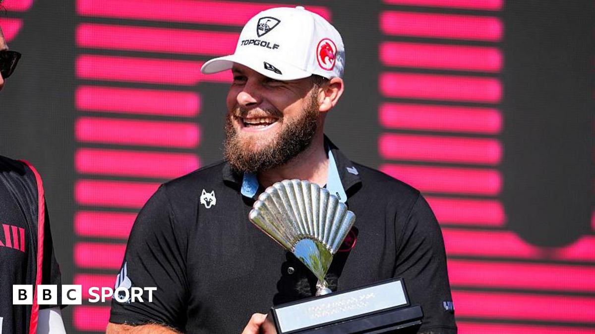 Tyrrell Hatton smiles as he holds the trophy for winning in Andalucia