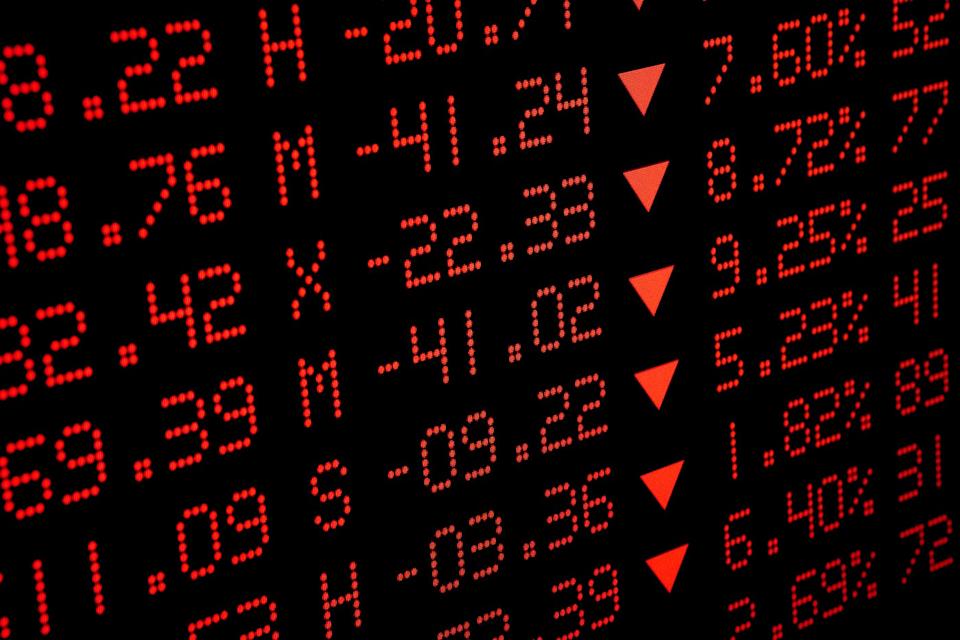 A digital display is showing many declining stock prices. 