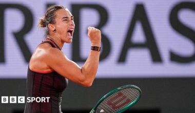 Aryna Sabalenka, wearing a black dress and holding her green racquet in her left hand, screams and clenches her right fist in celebration