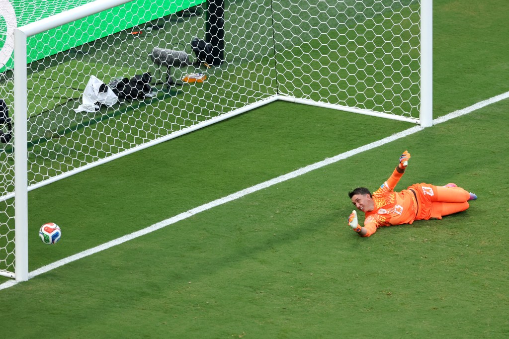 Uruguay's goalkeeper Fernando Muslera lies on the ground after Spain scores a goal in the 2026 FIFA World Cup.