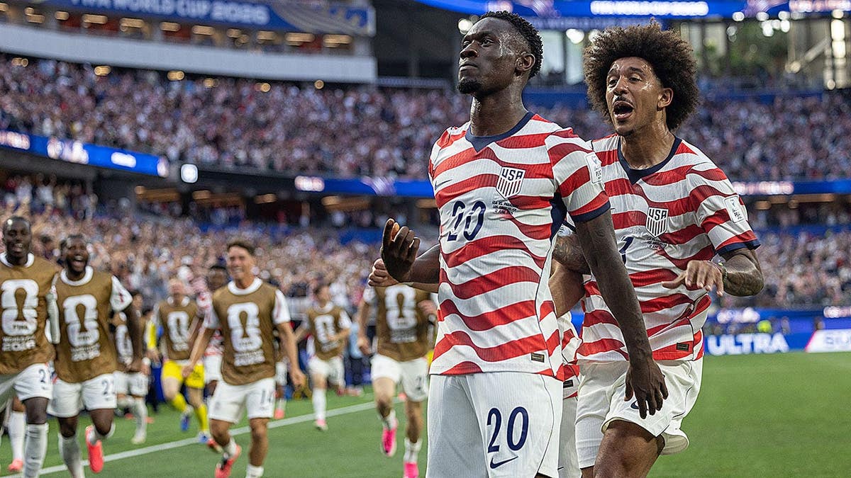 Folarin Balogun celebrating with teammates after scoring a goal at Los Angeles Stadium.