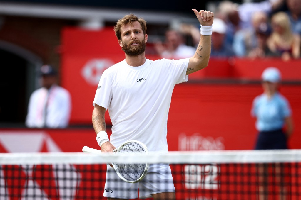 Corentin Moutet celebrates his victory at Queen's Club in west London.
