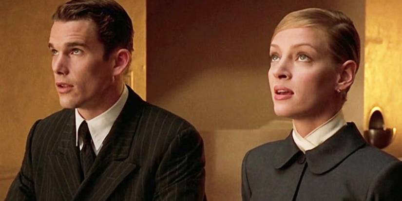 Ethan Hawke and Uma Thurman looking up in their uniforms in Gattaca