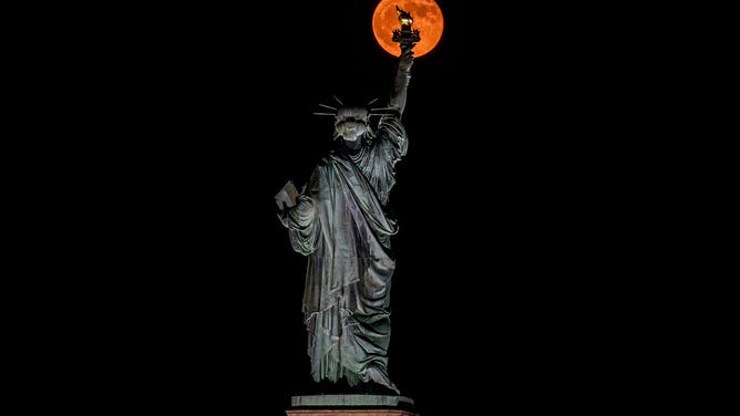NEW JERSEY, UNITED STATES - JUNE 11: The Strawberry Moon as seen from Jersey City, NJ on June 11, 2025. This moon has the distinction of being the lowest in the sky since 2006 and won't happen again until 2043.
