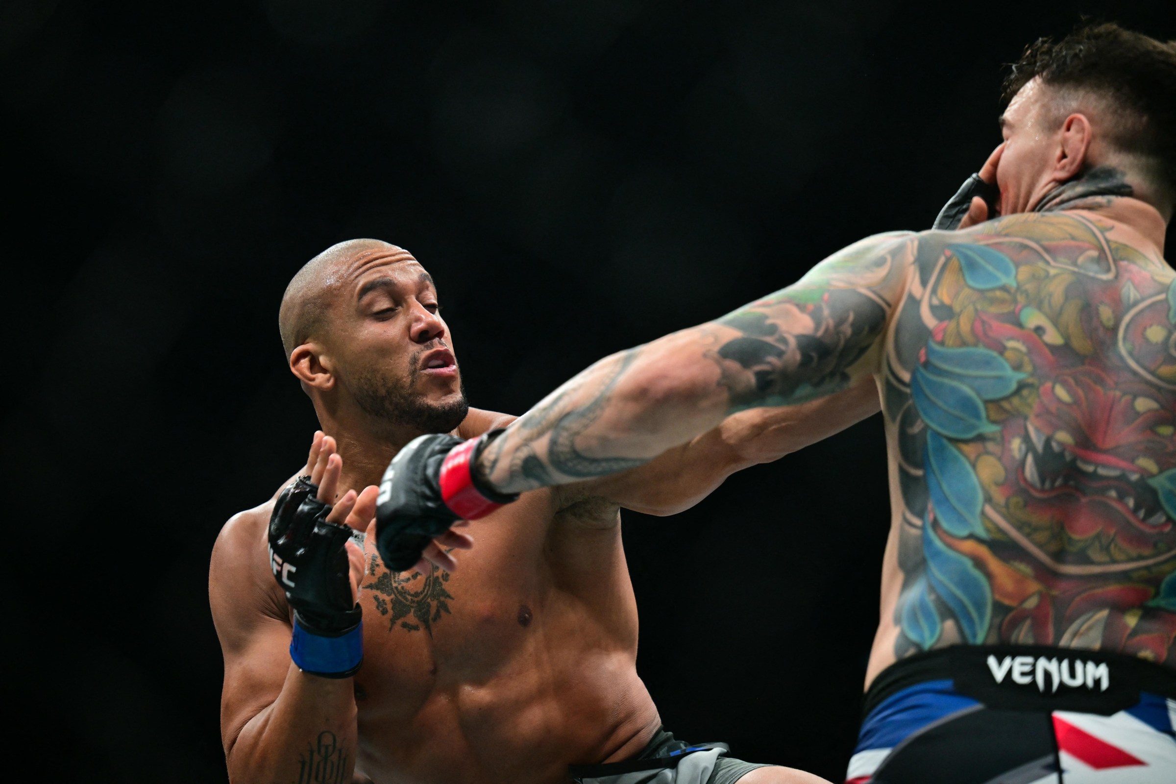 TOPSHOT - France’s Ciryl Gane (L) fights Britain’s Tom Aspinall during their UFC heavyweight title bout at UFC 321 at Etihad Arena in Abu Dhabi early on October 26, 2025. (Photo by Giuseppe CACACE / AFP via Getty Images)