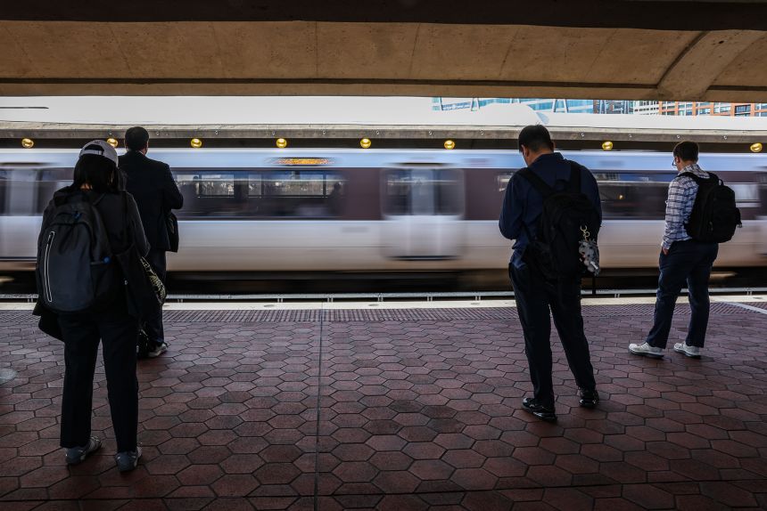 Commuters wait for the metro in Alexandria, Virginia, on March 11, 2026.